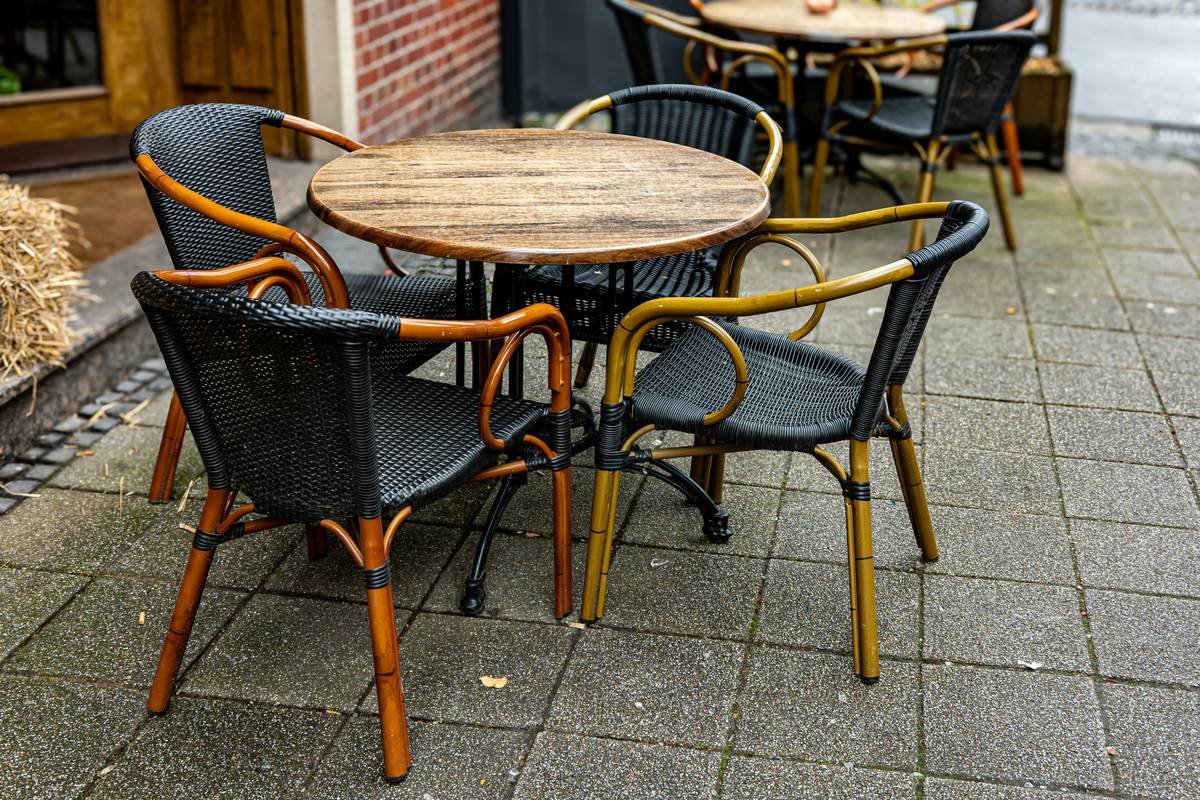 Close-up of patio dining garden benche can wooden showing joinery details and weathered finish